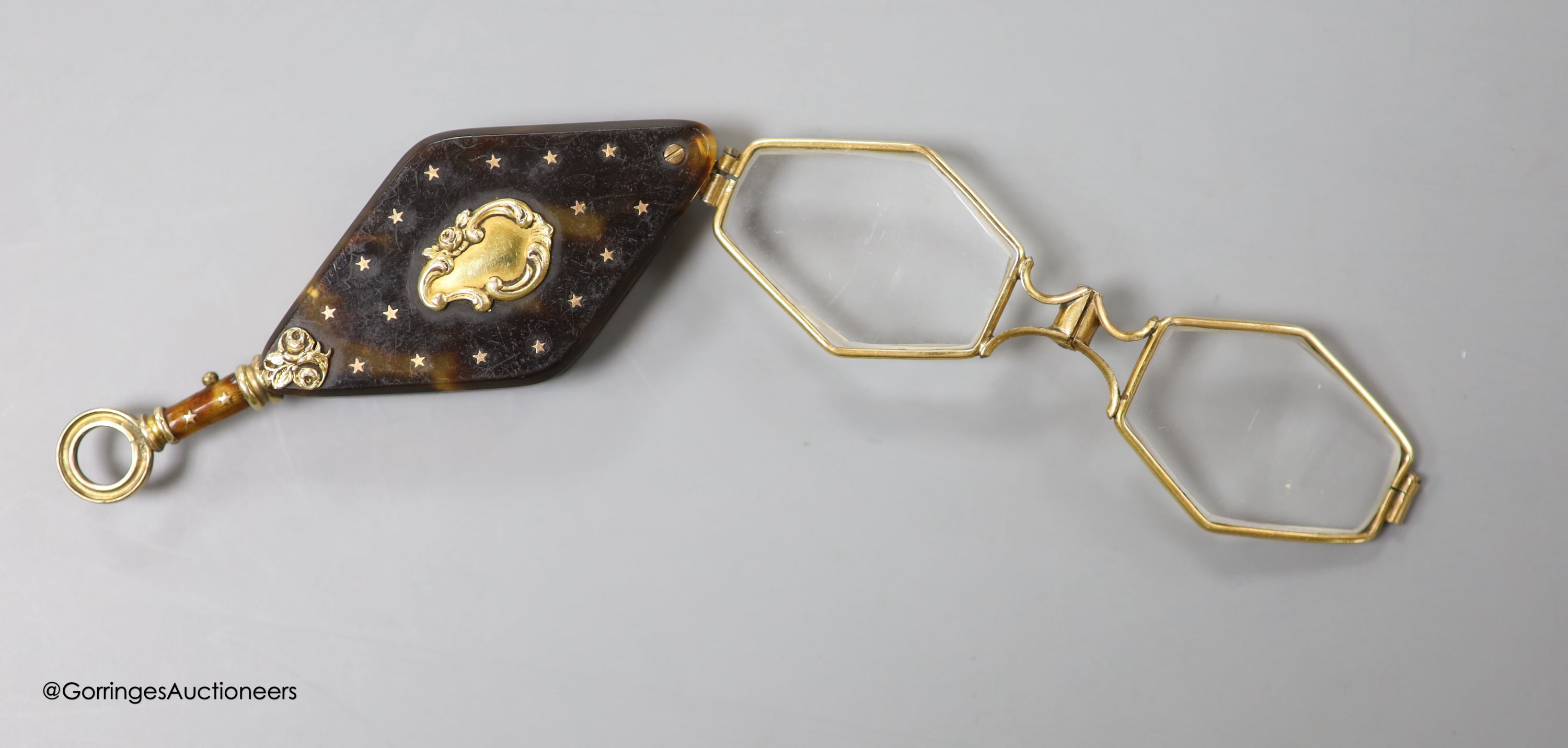 A pair of 19th century French tortoiseshell pique mounted yellow metal overlaid lorgnettes, 82mm.